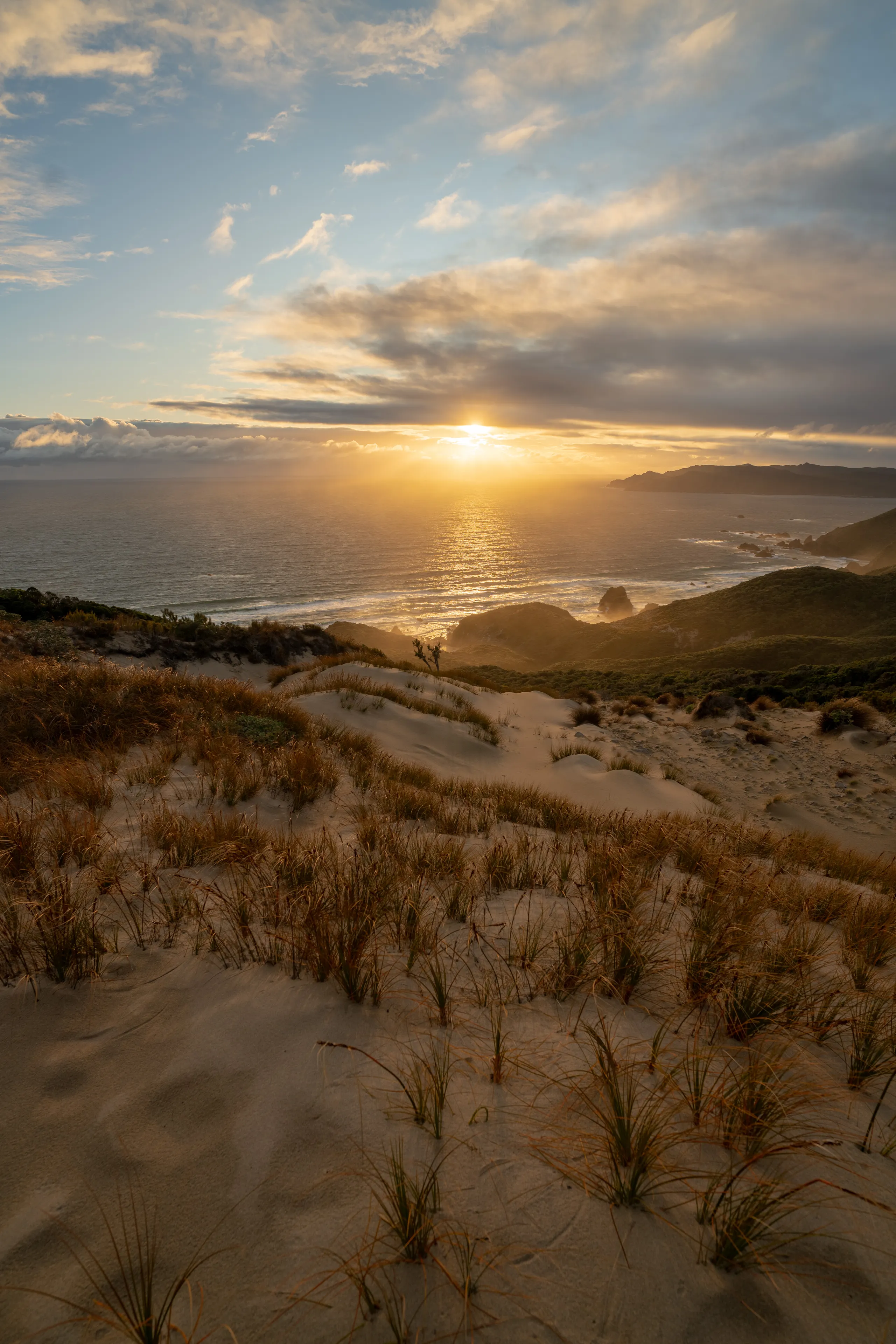 Sunset from the top of the Hellfire sand dune with Codfish Island / Whenua Hou visible in the background